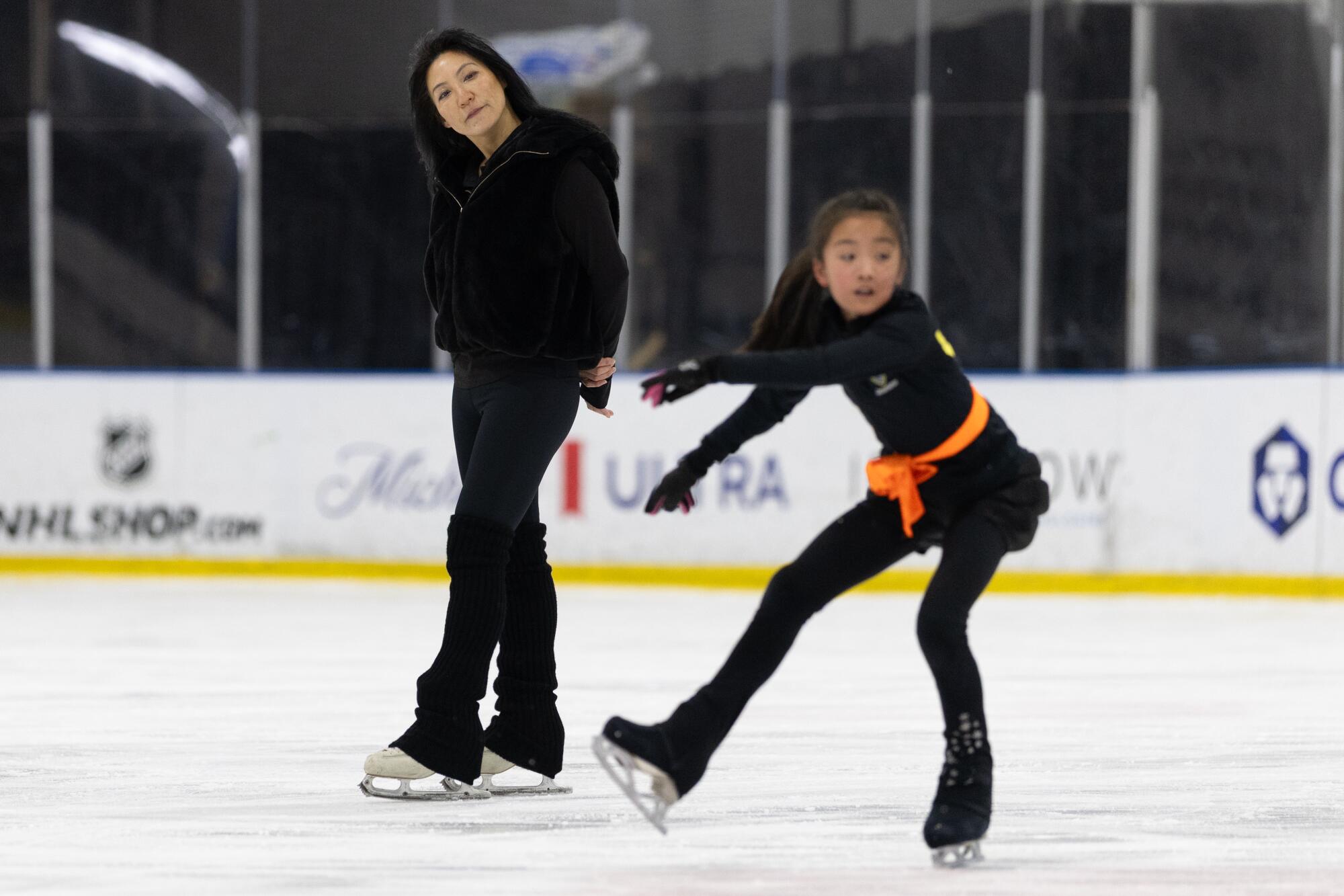Tiffany Chin watches one of her figure skating students practice on the ice.
