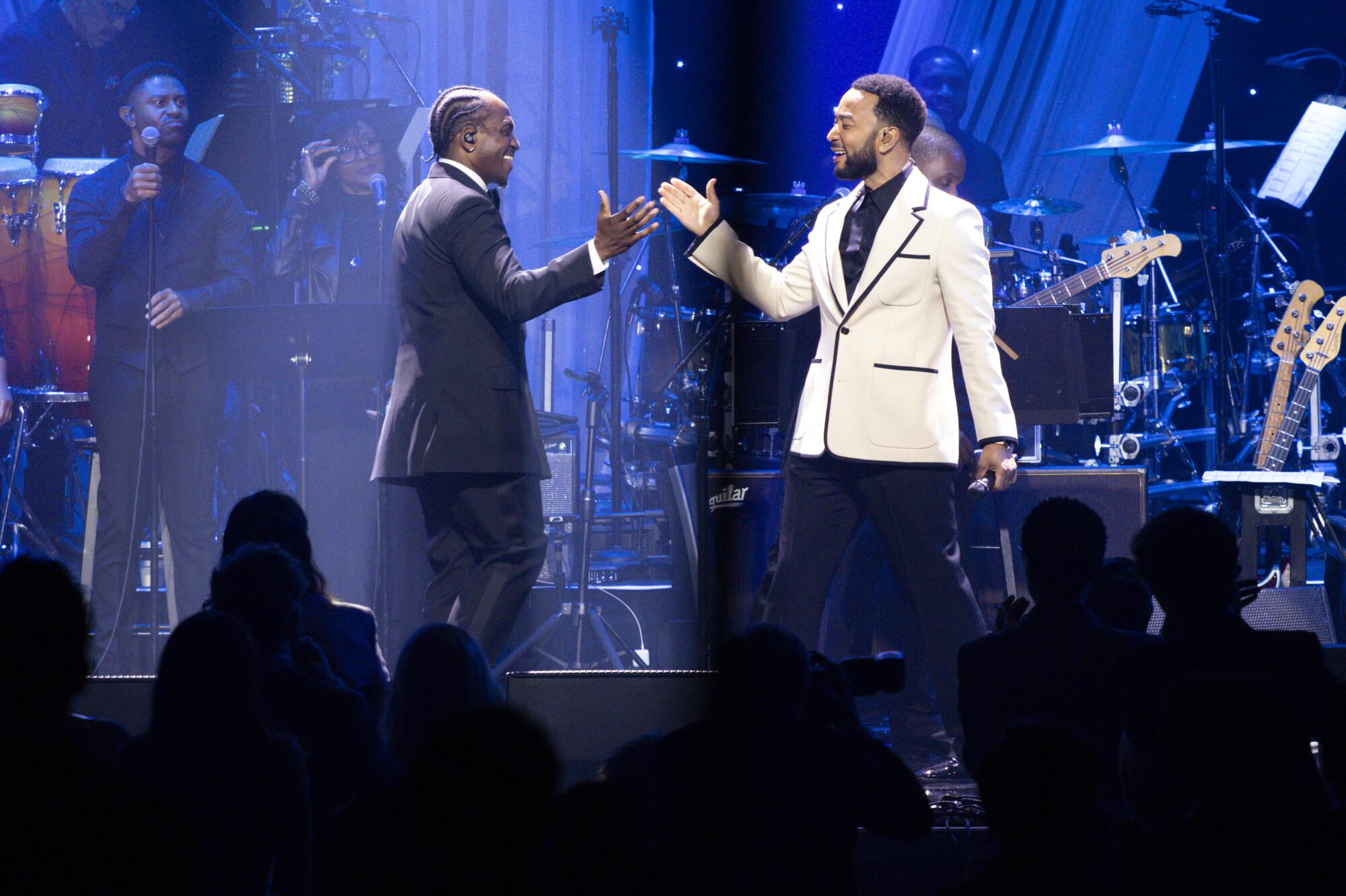Pusha T of Clipse, left, and John Legend perform.