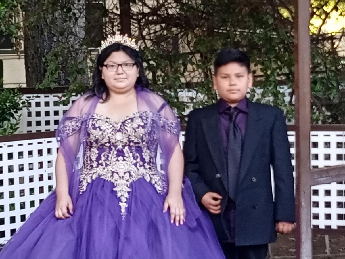 Marie Pineda poses for a photo during her quinceañera with her brother, Daniel Pineda. 