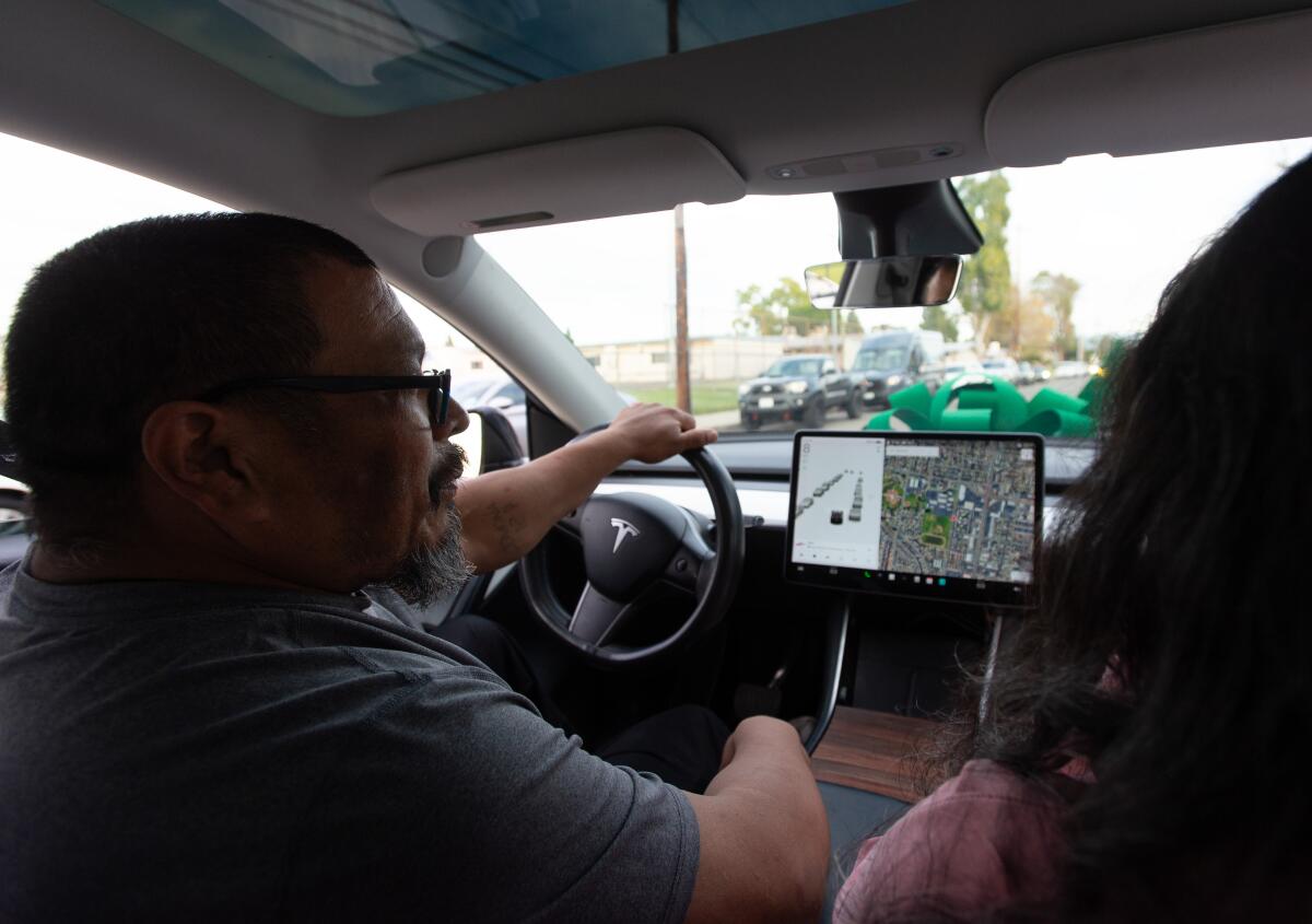 Patricio Pineda takes his first drive in a Tesla Model UT that was gifted to his family Tuesday.