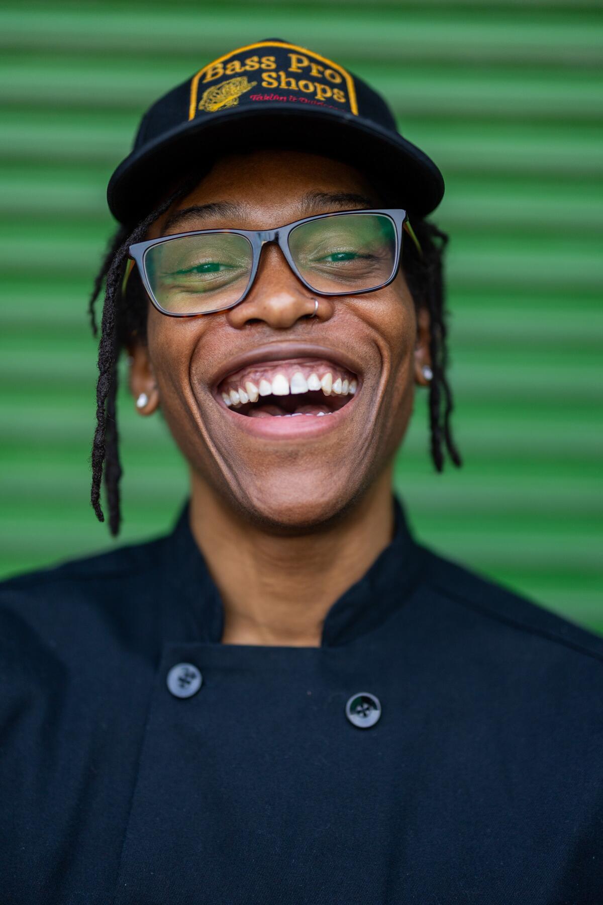 Chef Wolf Collins smiles outside of the Crenshaw Food Hub.