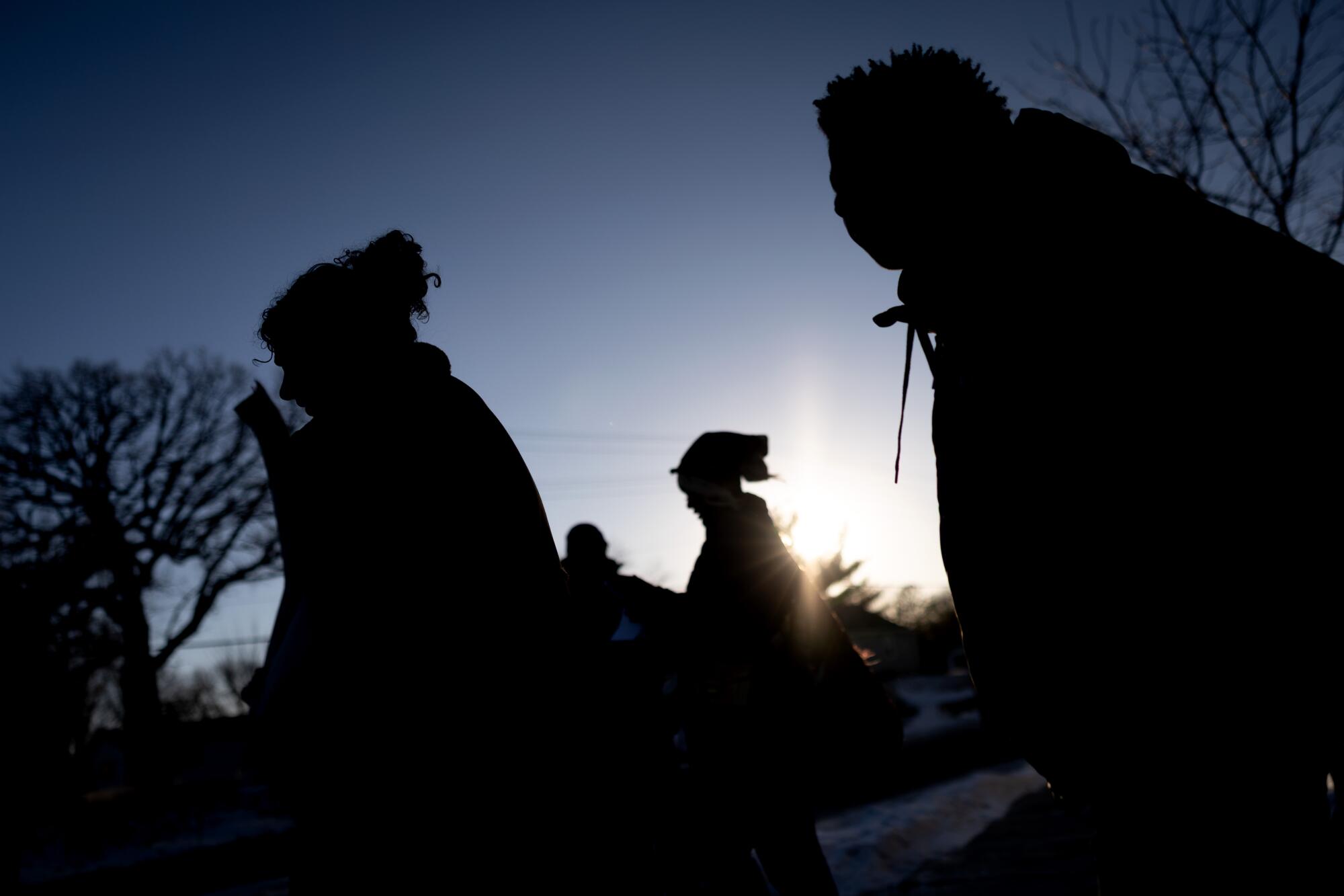 students walk to a bus