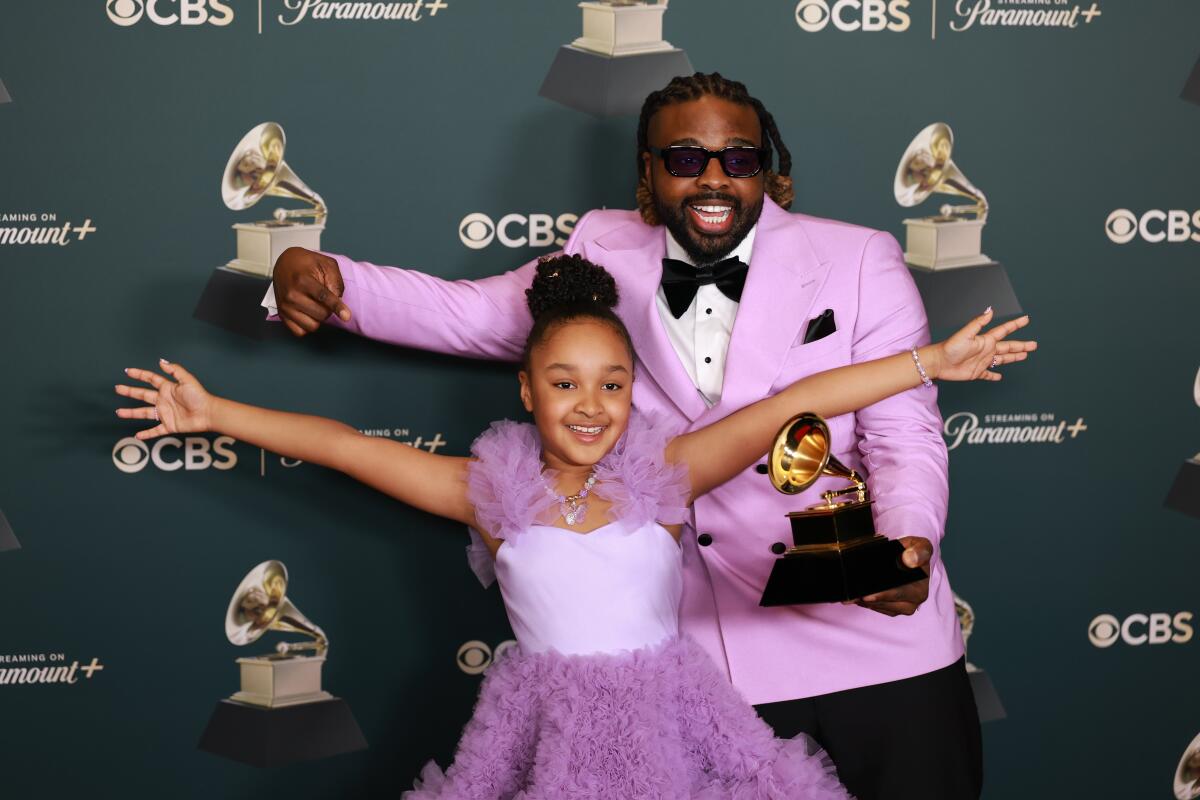 Aura V and Fyütch hold their Grammy. 