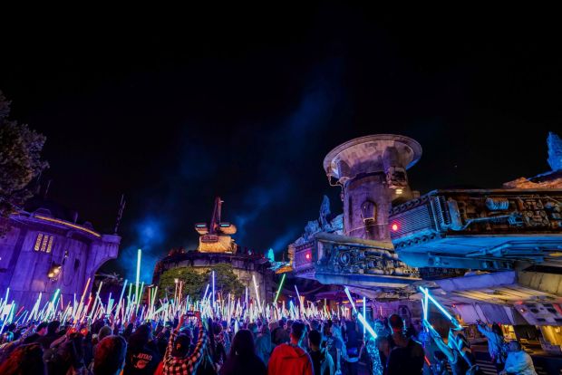 Visitors raise their lightsabers on Star Wars Nite in Galaxy's Edge during Disneyland After Dark at the Anaheim theme park. (Courtesy of Disneyland)