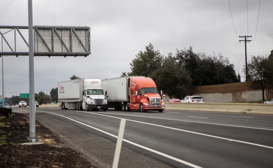 Semi-trucks traveling down Highway 99 in Fresno on Feb. 25, 2023.