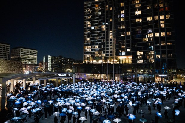 A general view as participants march with umbrellas printed with aerial photographs at City Hall in San Jose, Calif., on Saturday, Jan. 31, 2026. (Thien-An Truong for Bay Area News Group)