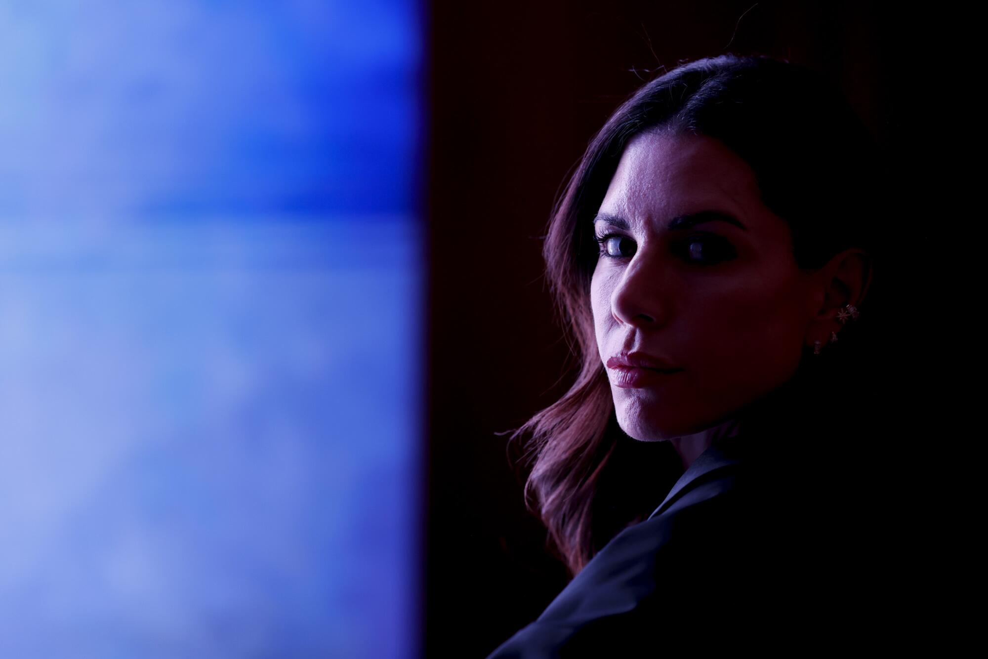 A woman's face in half shadow.