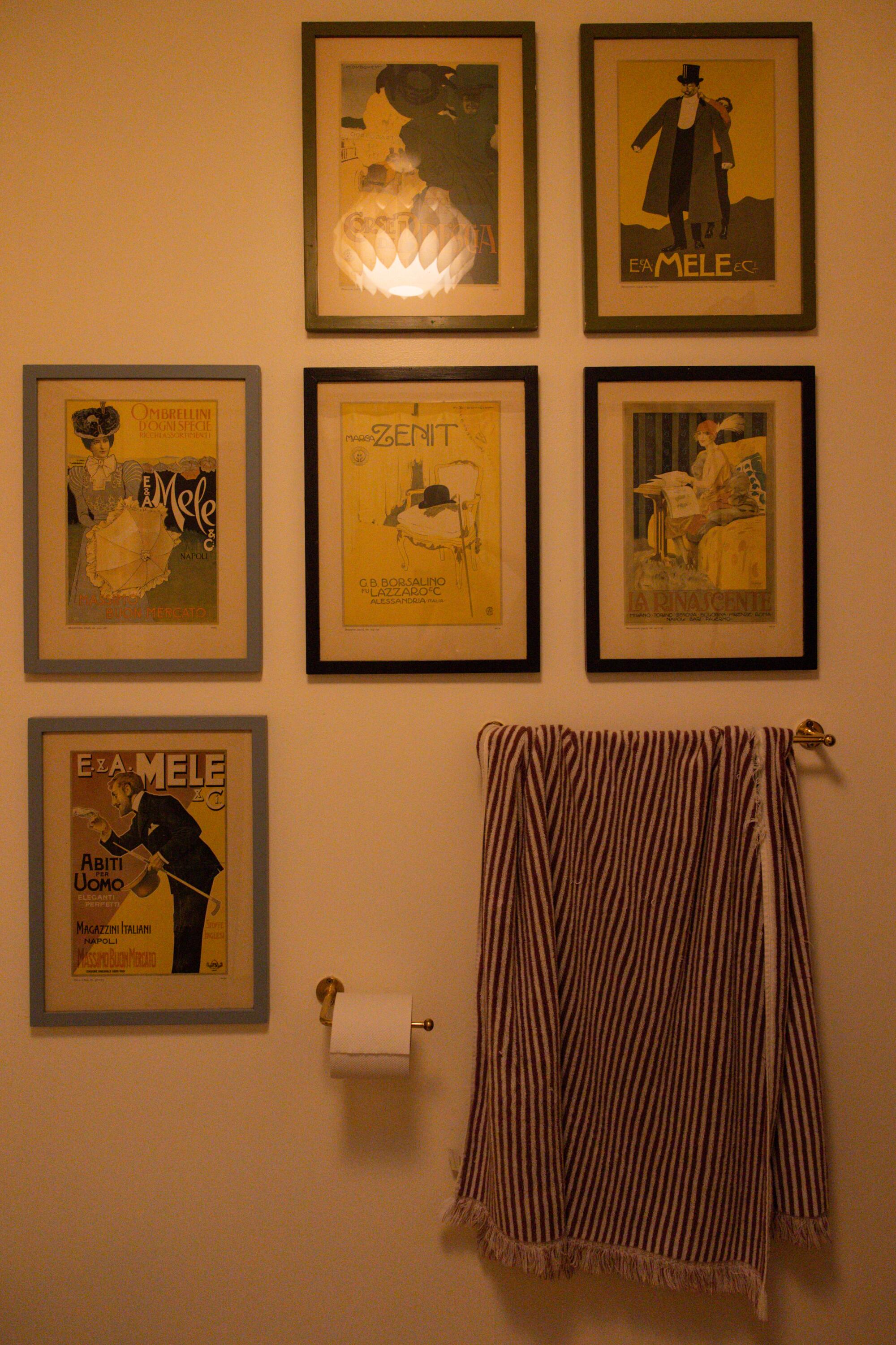 A gallery wall decorates the bathroom in Adams' home.