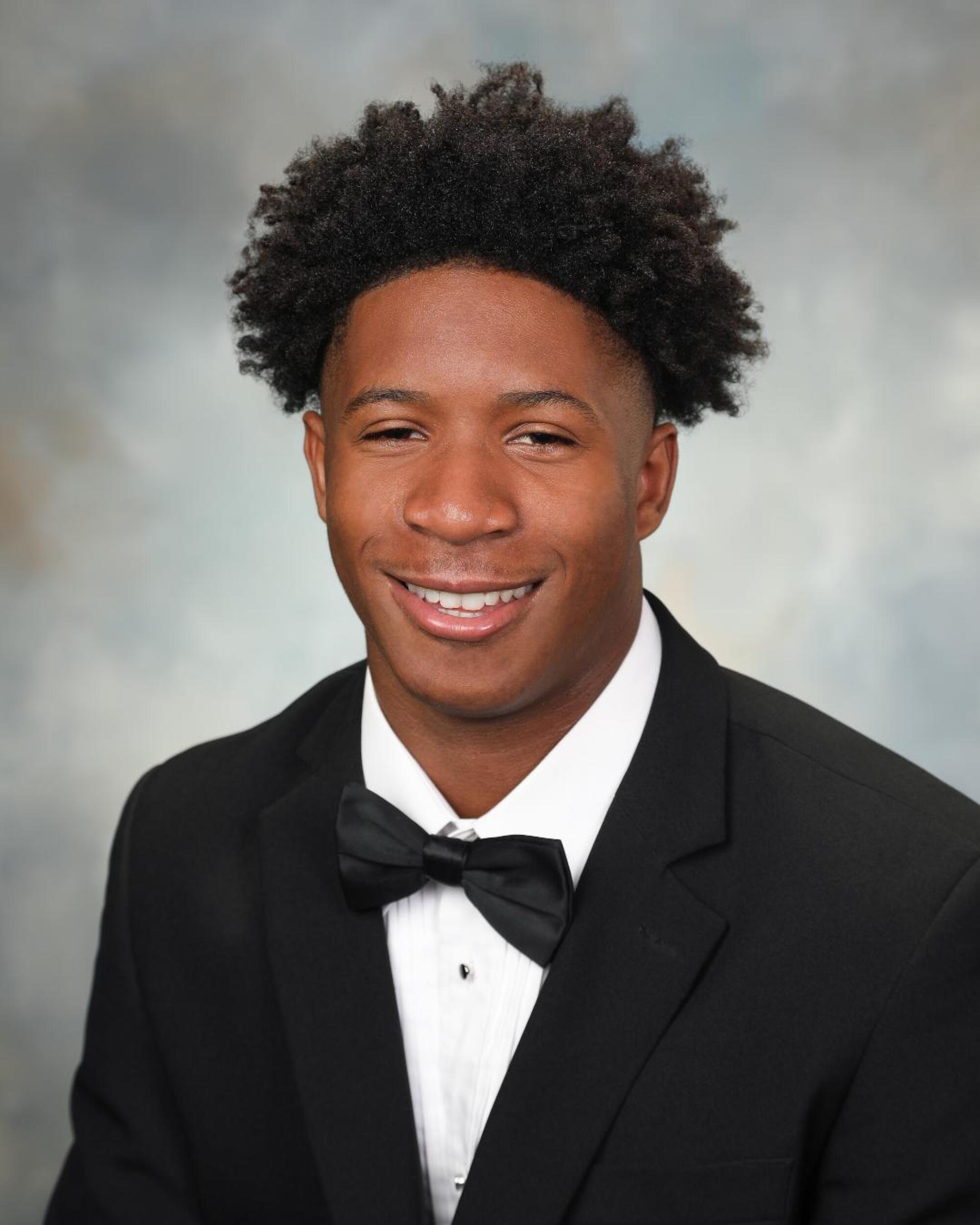 Former St. Monica receiver Kyle Williams poses for a photo in a tuxedo and bow tie.
