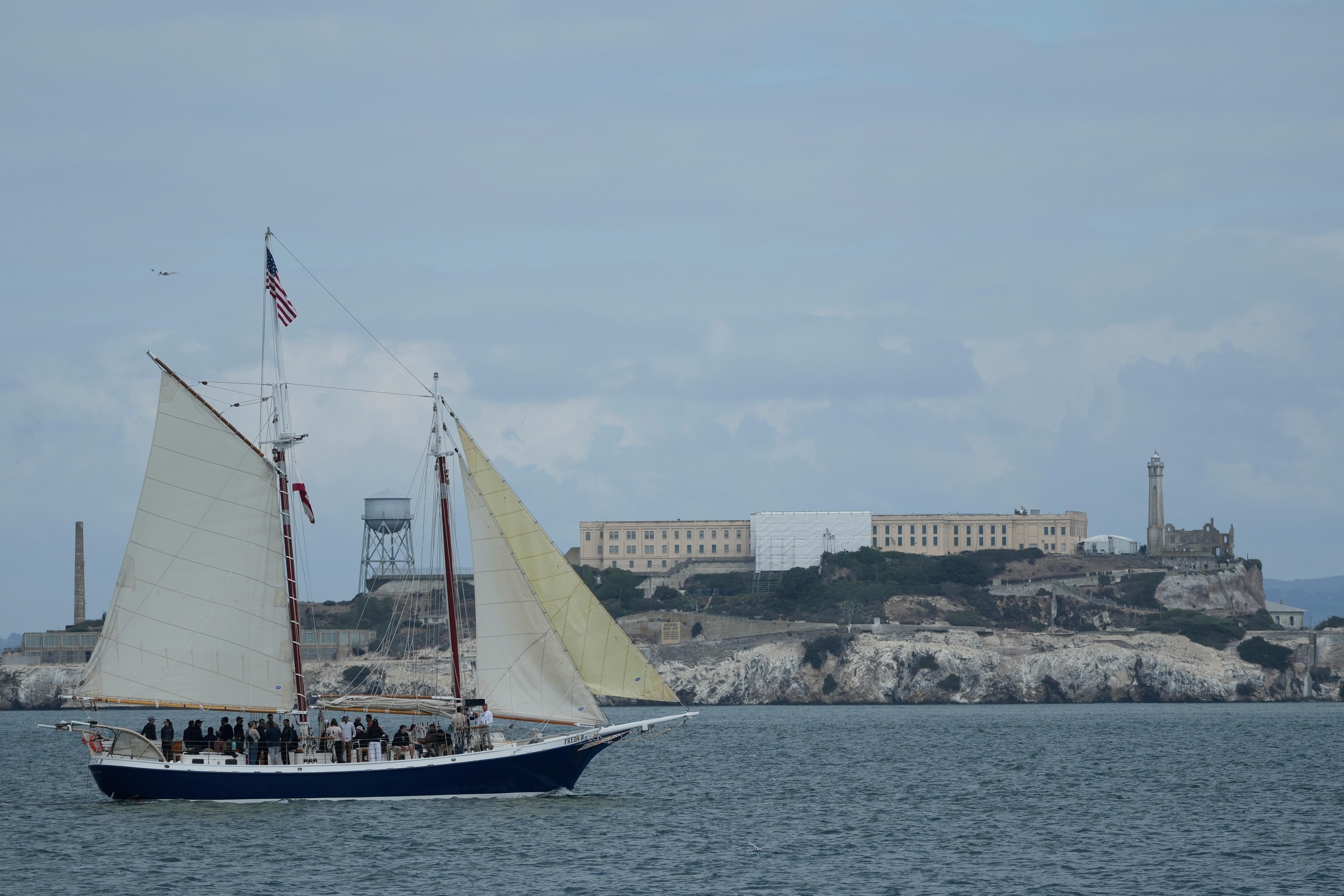 A boat sails in front of Alcatraz Island in San...