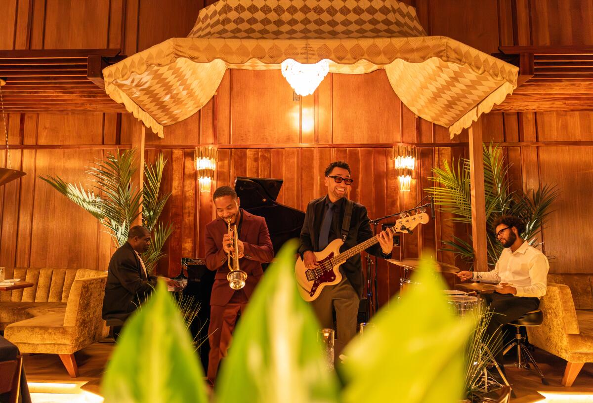 The in-house band the Somerville Quartet play music on a stage