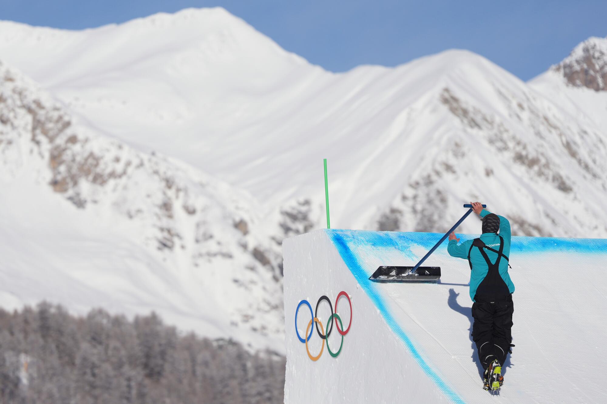 A worker preps a ramp before a freestyle skiing slopestyle training session in Livigno, Italy, on Thursday.