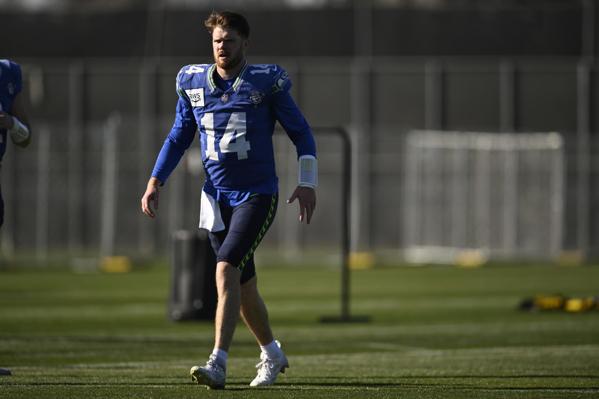 Sam Darnold walks on the practice field at San Jose State University on Wednesday ahead of Super Bowl LX.