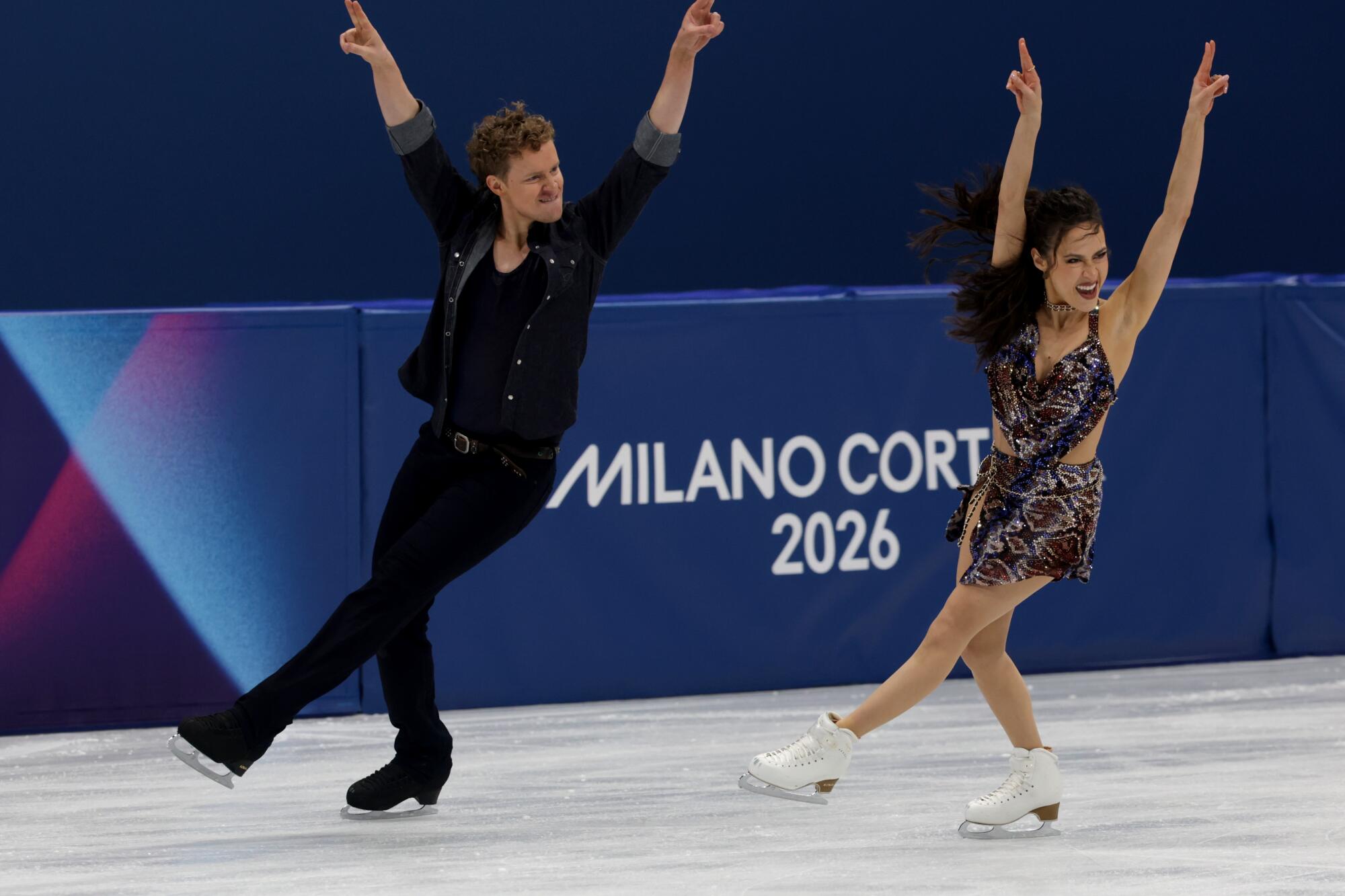 Evan Bates, left, and Madison Chock compete in rhythm dance during the figure skating team competition.