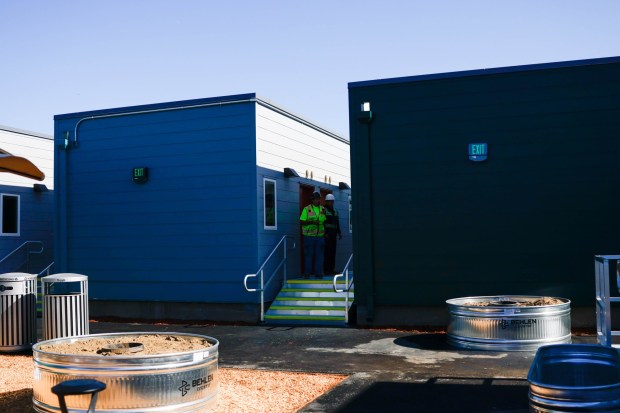 Construction workers look inside the rooms at San Jose's last emergency interim housing site at the VTA's Cerone Yard in San Jose, Calif., on Thursday, Feb. 5, 2026. (Shae Hammond/Bay Area News Group)