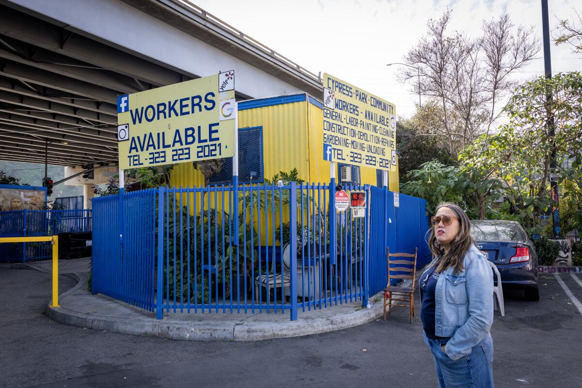 A woman stands outside a day labor center at the Cypress Park Home Depot.