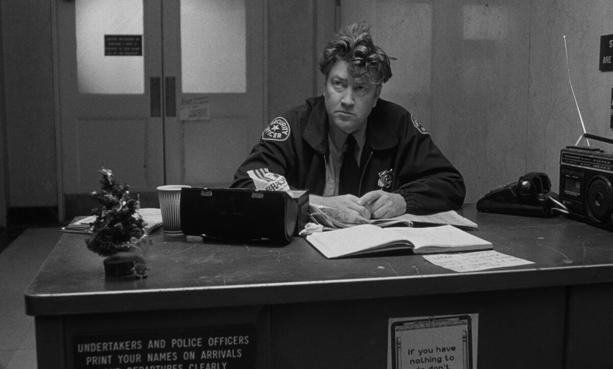 A man looks up from his desk.
