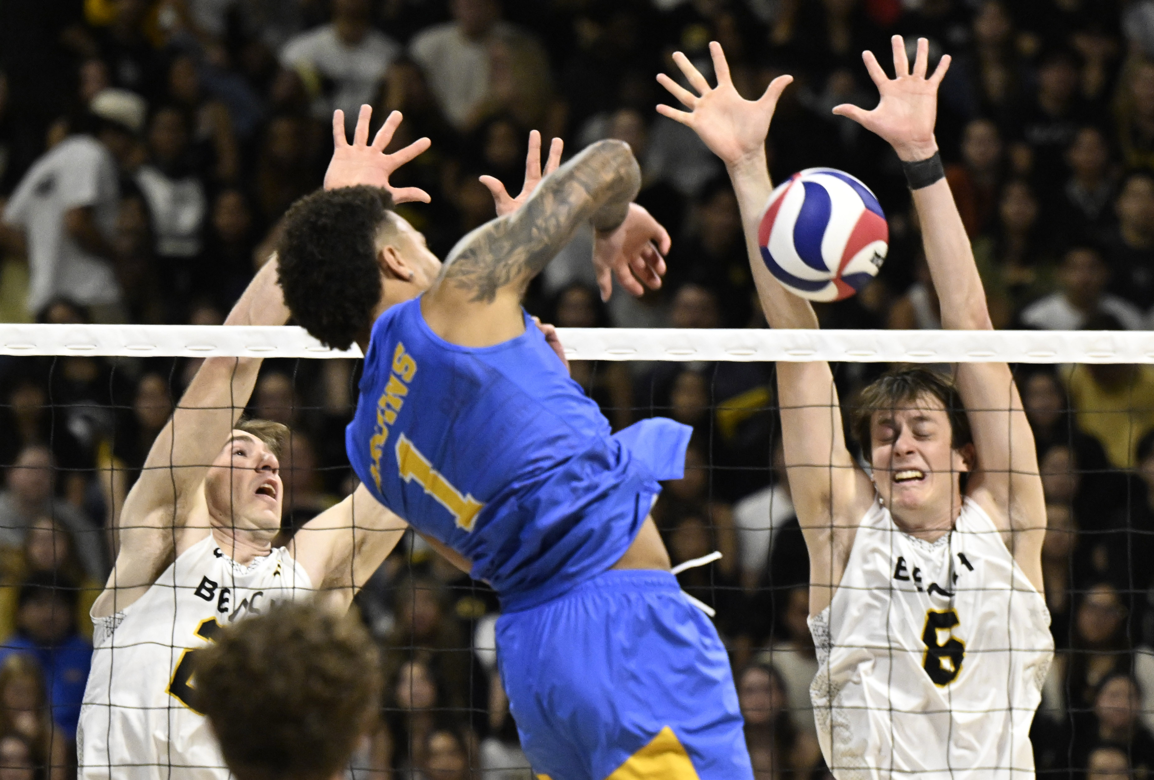 UCLA middle blocker Cameron Thorne (1) spikes the ball against...