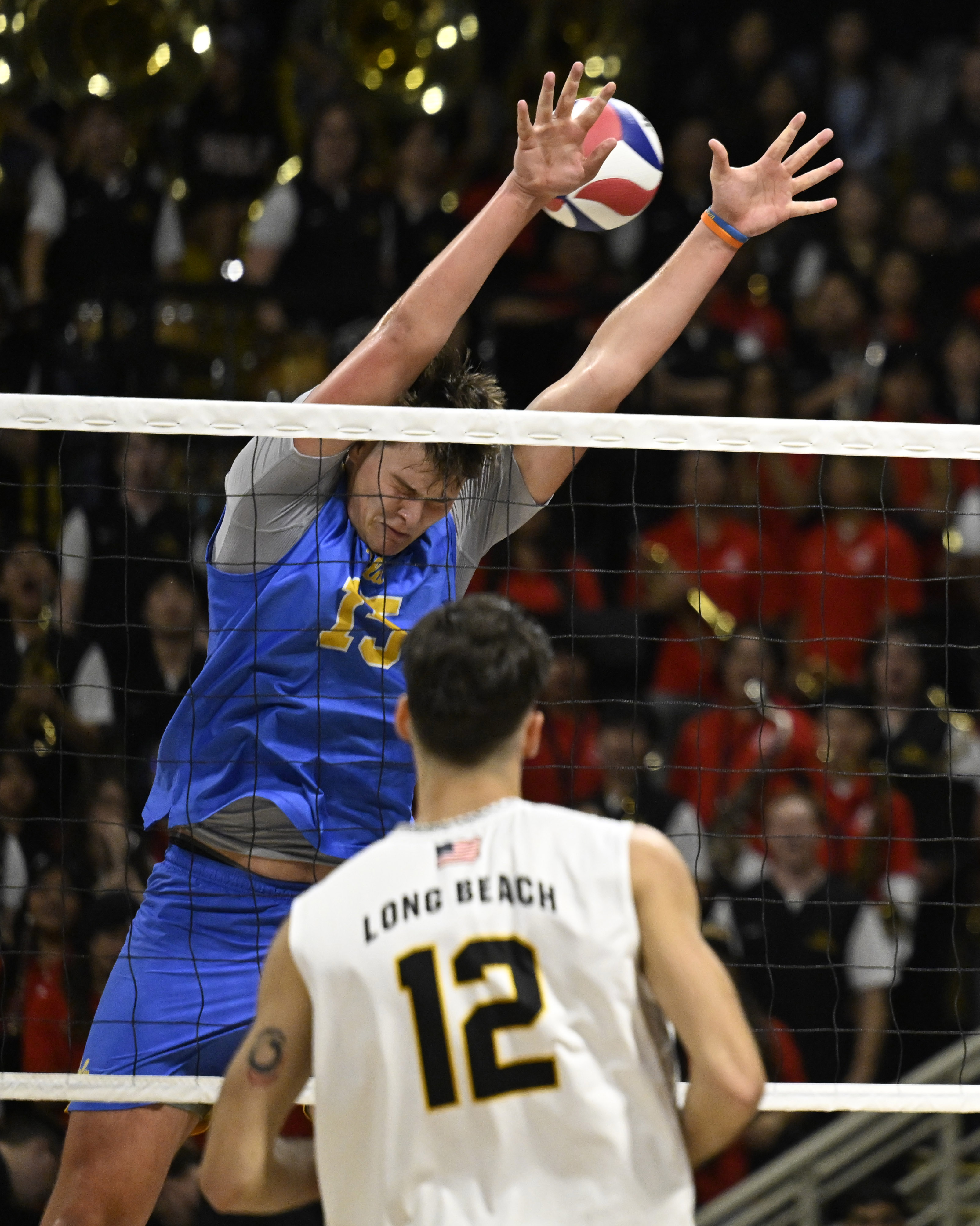 UCLA middle blocker Christopher Hersh, top, canât block a shot...
