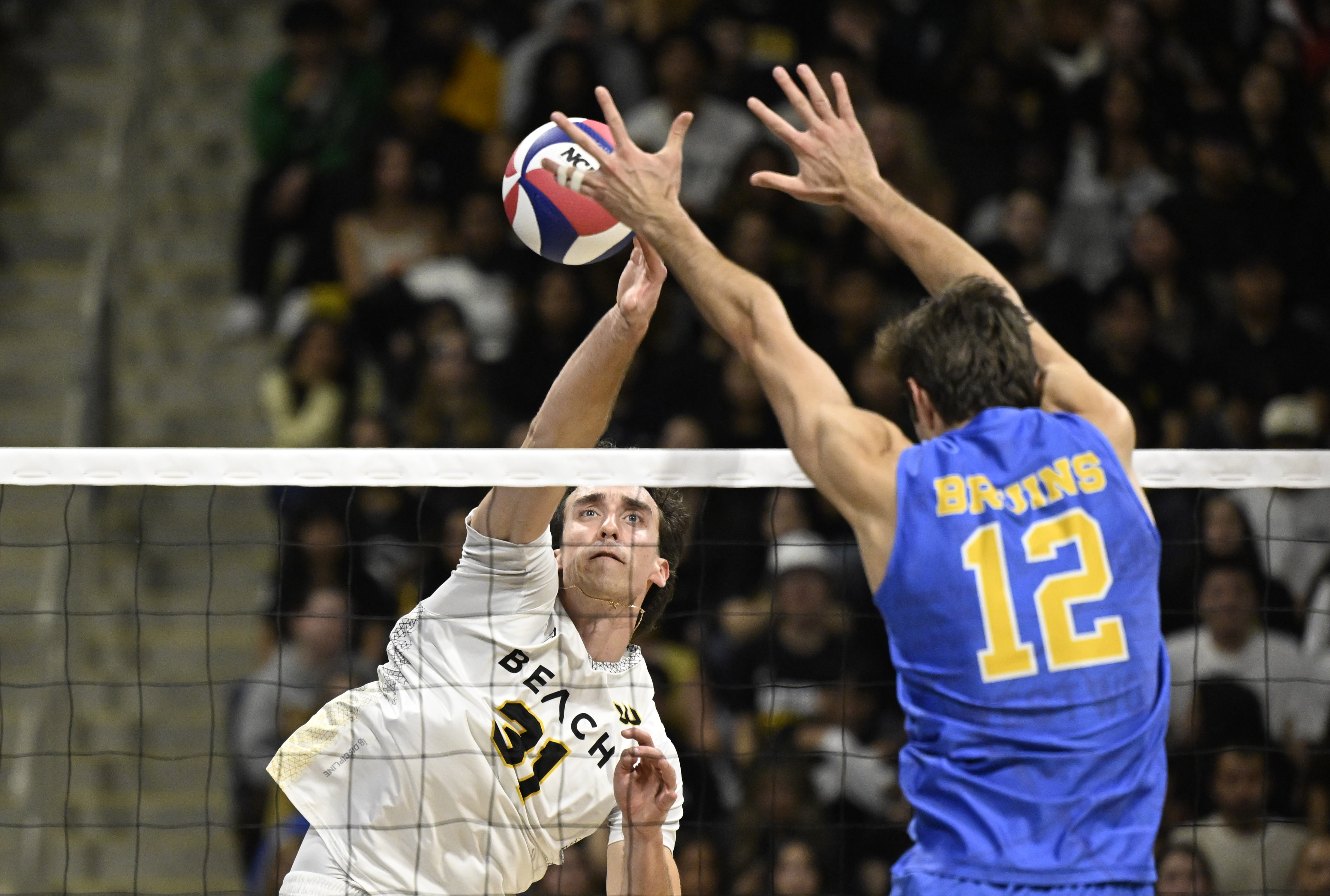 Long Beach State opposite hitter Daniil Hershtynovich, left, hits as...