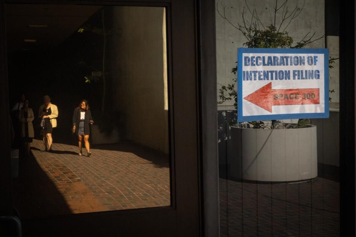 A candidate arrives to file to run for office in the the 2026 Municipal elections at the city clerk's office