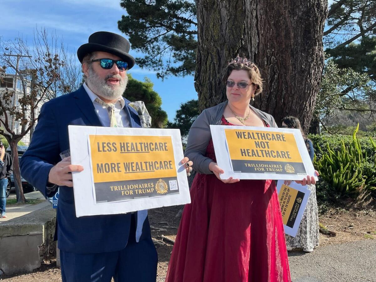 Two counter-protesters mockingly impersonated billionaires.