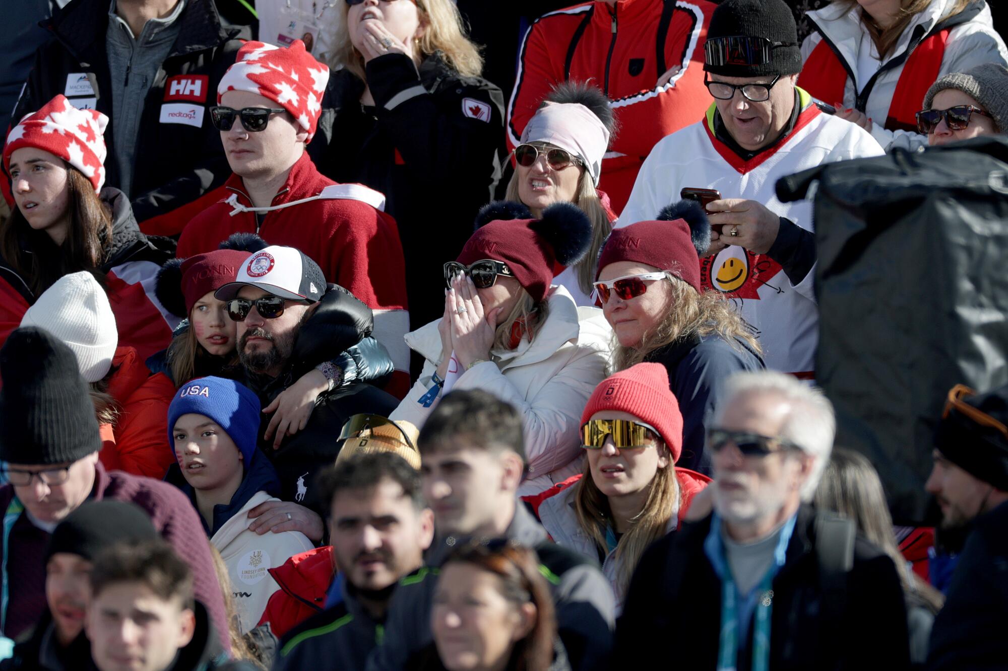 Fans react after watching American Lindsey Vonn crash during the women's downhill skiing race at the Winter Olympics Sunday.