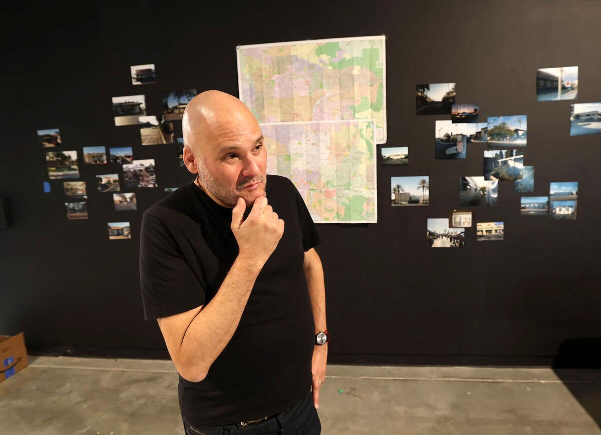 Artist Carlos Viani at his "Next of Kin" exhibition at the Grand Central Art Center in Santa Ana. 