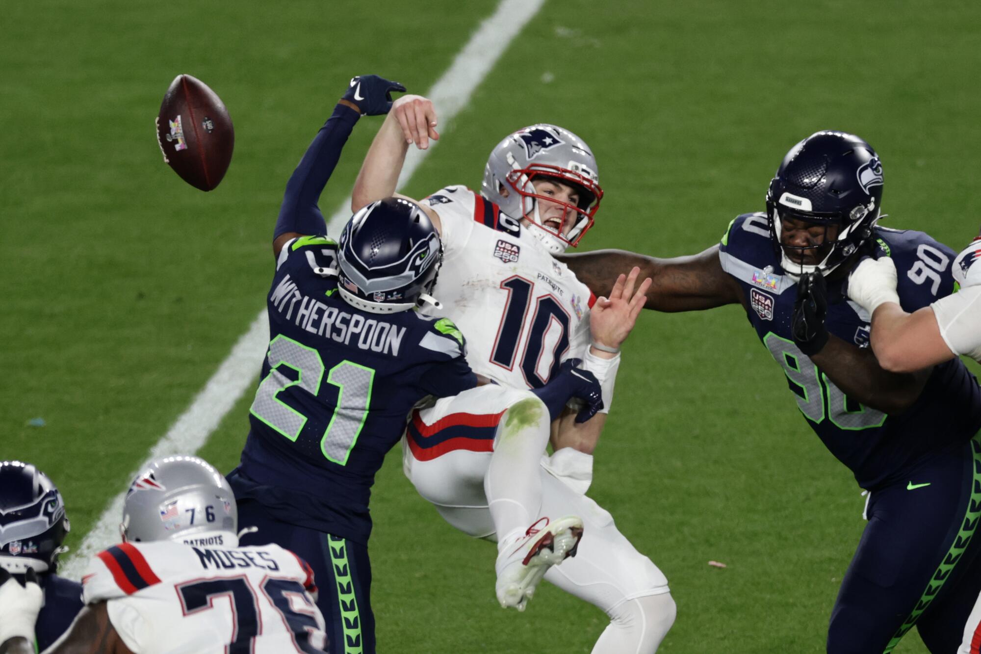 Seattle Seahawks cornerback Devon Witherspoon (21) forces a fumble against New.