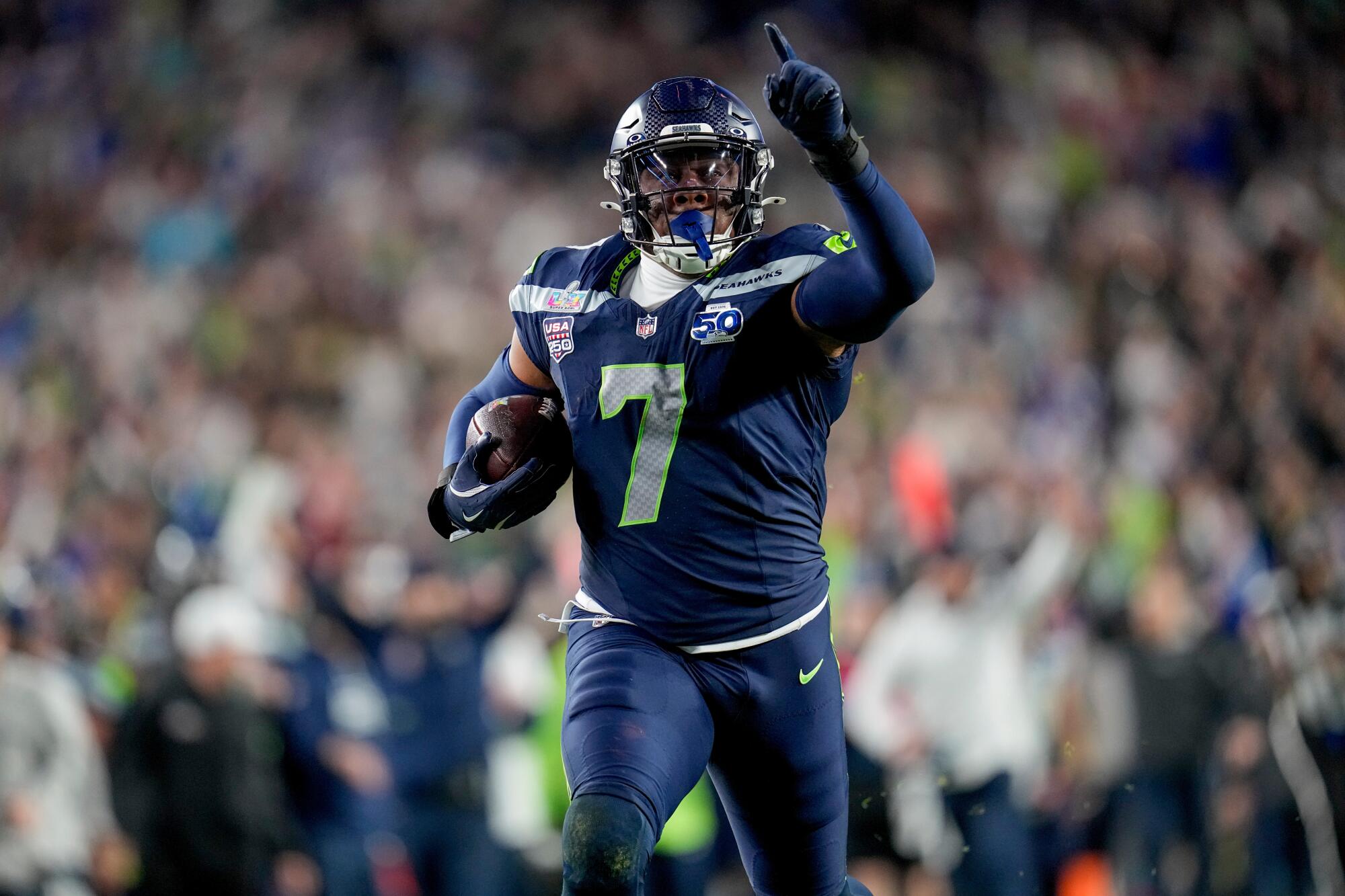 Seattle Seahawks linebacker Uchenna Nwosu celebrates after returning an interception.