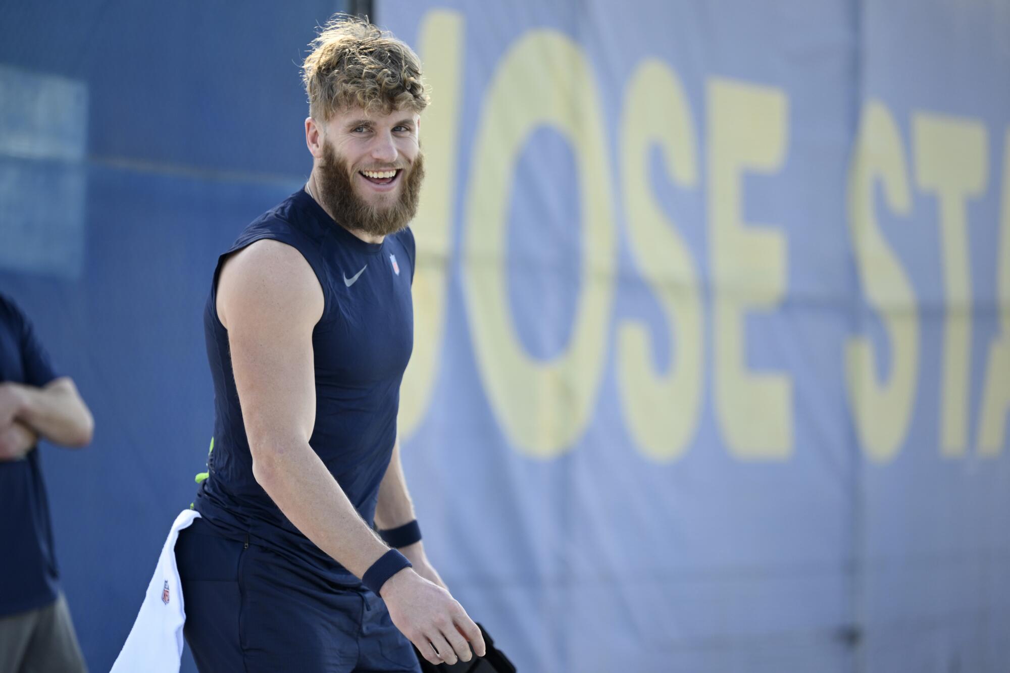 Former Rams wide receiver Cooper Kupp smiles on the practice field.