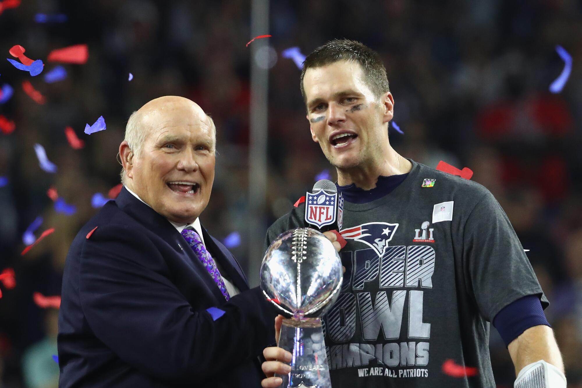 Terry Bradshaw interviews Tom Brady after Super Bowl 51. Brady holds the Lombardi trophy.