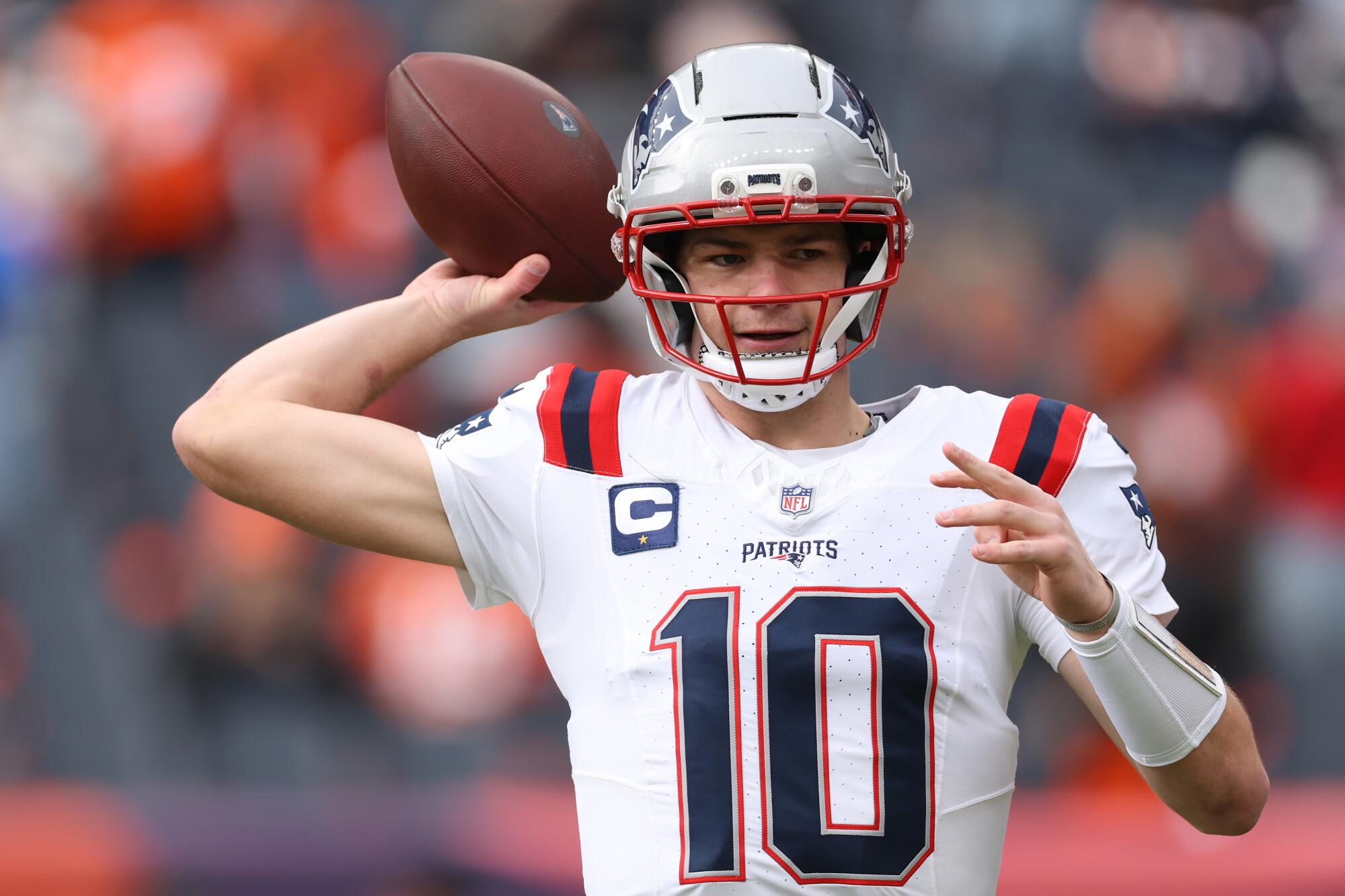 New England Patriots quarterback Drake Maye warms up before facing the Denver Broncos.