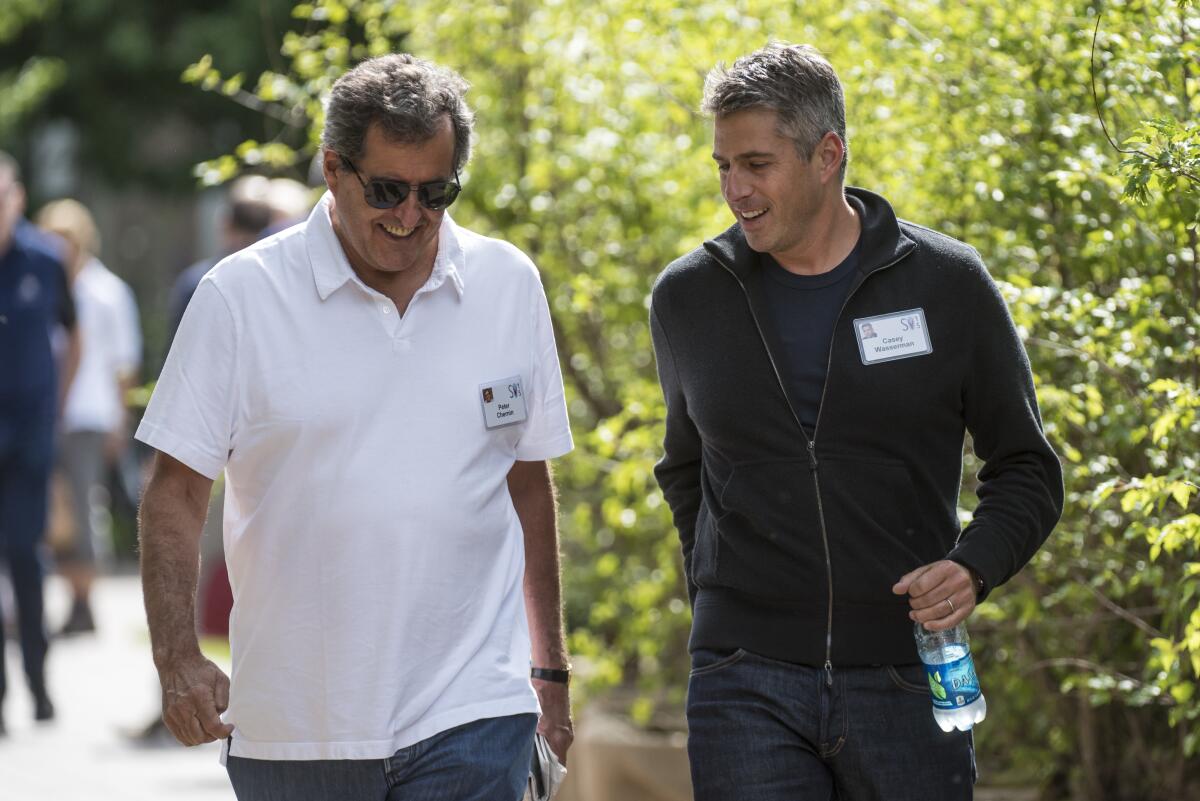 Peter Chernin, former president of News Corp., left, Casey Wasserman, chief executive officer of Wasserman Media Group, walk
