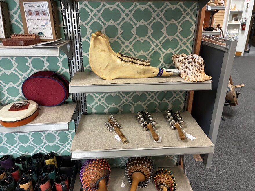 A donkey jaw sits next to a conch shell on a shelf at Lark in the Morning.