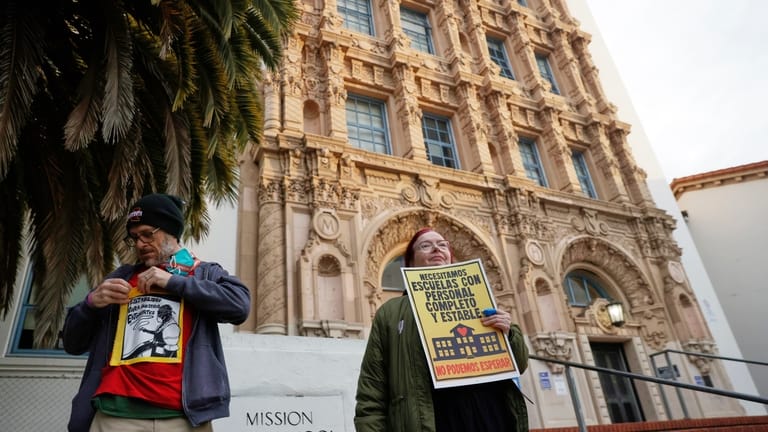 Teachers picket in front of Mission High School in San...