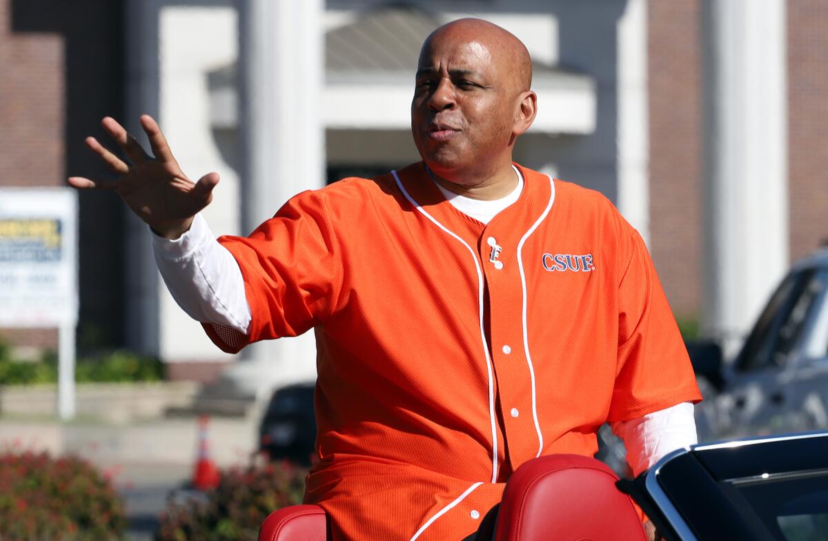 Parade Grand Marshal Ronald Rochon waves to the crowd during the 46th Annual Orange County Black History Parade on Feb. 7.