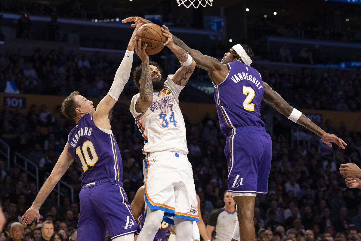 Thunder guard Kenrich Williams is double teamed by Luke Kennard and Jarred Vanderbilt in the first half.