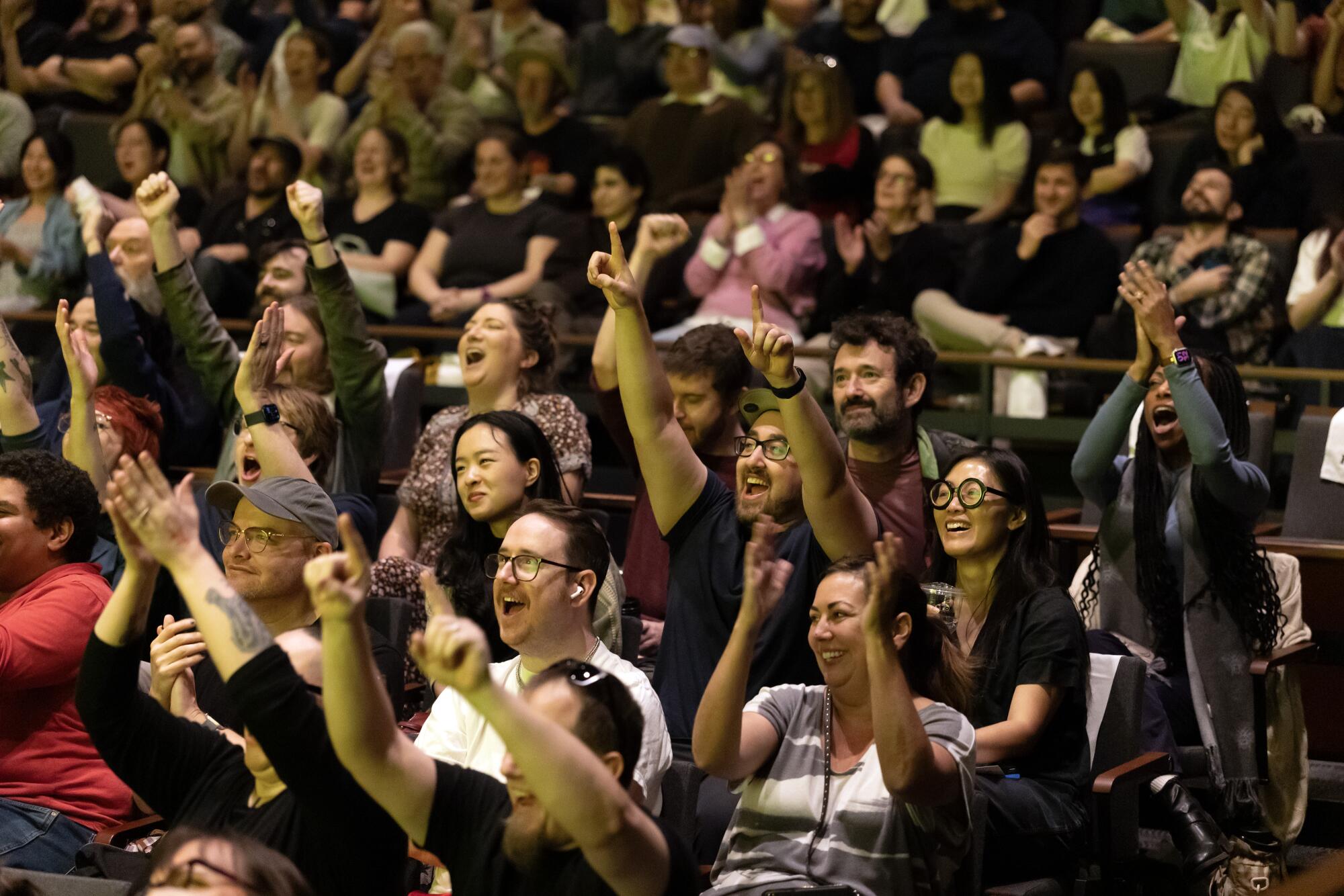 The audience cheers various decisions made during the playing of "asses.masses" at UCLA Nimoy Theater.