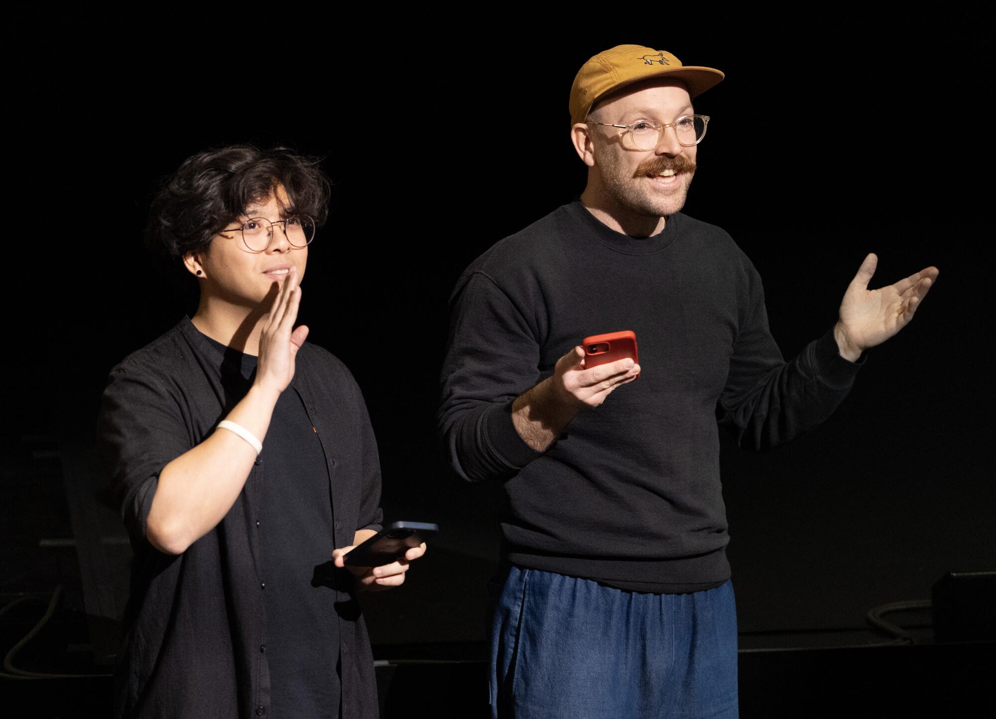 Two artists and video game creators in black tops.