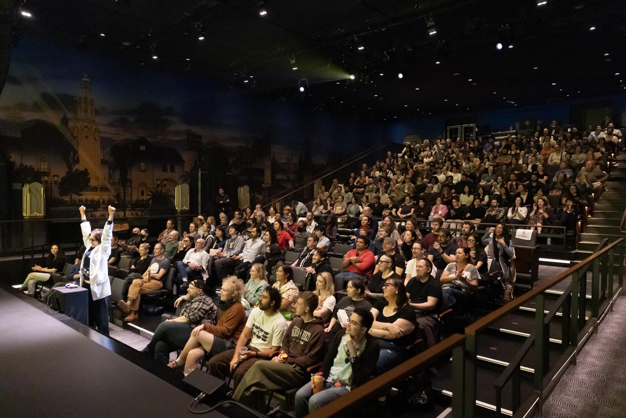 A player celebrates during "asses.masses," live action theatrical video game.