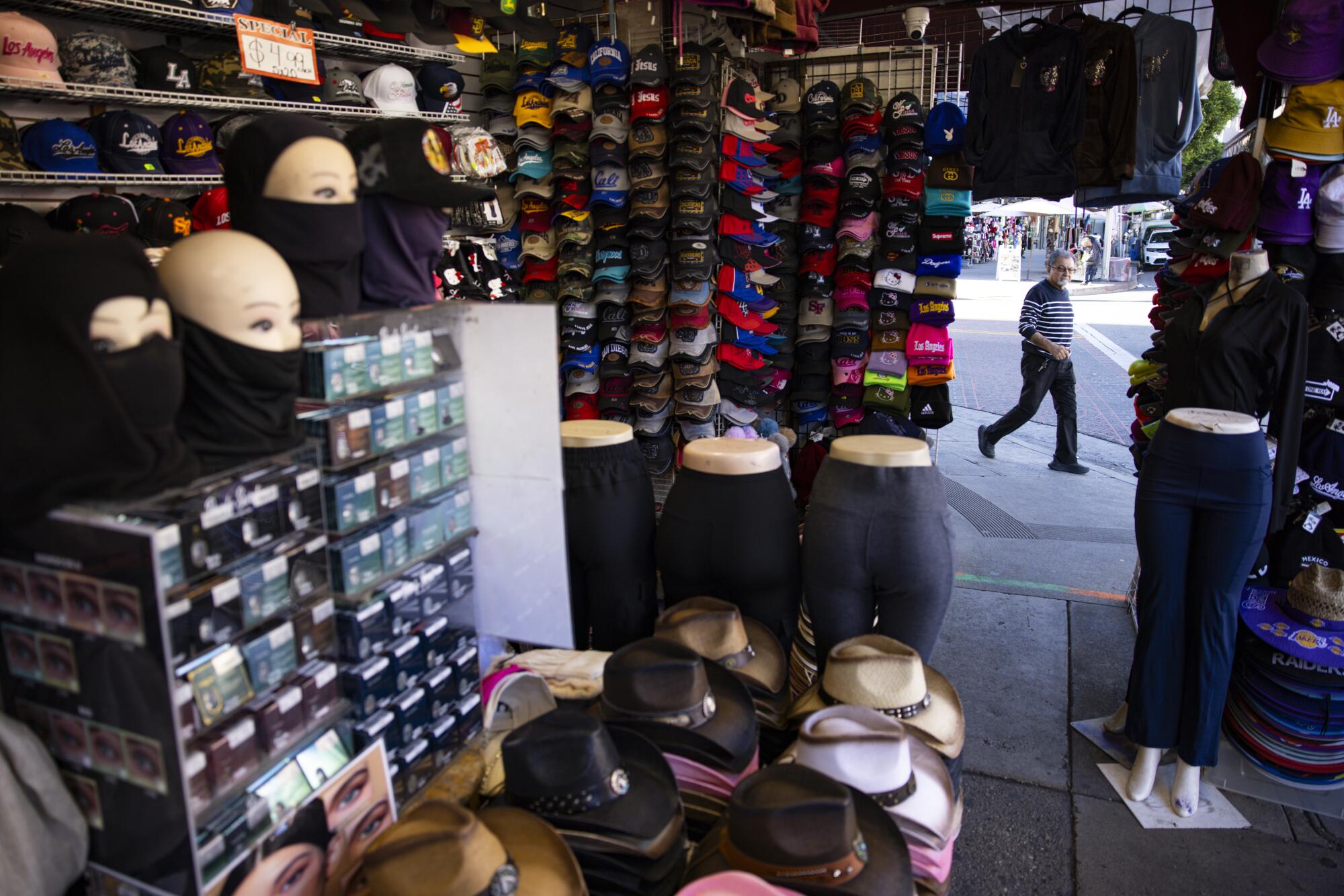 A visitor walks past a shop in the Fashion District.