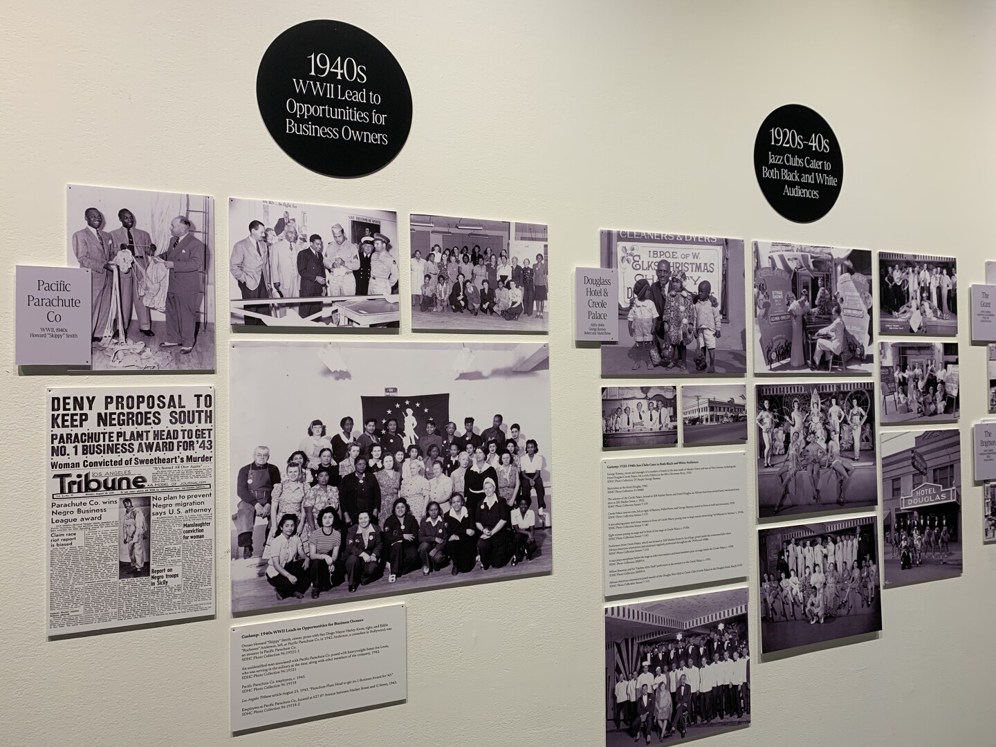 Circular signs denoting pictures showing San Diego neighborhoods from the 1920s through the 1940s are shown at the San Diego History Center on Feb. 4, 2026.