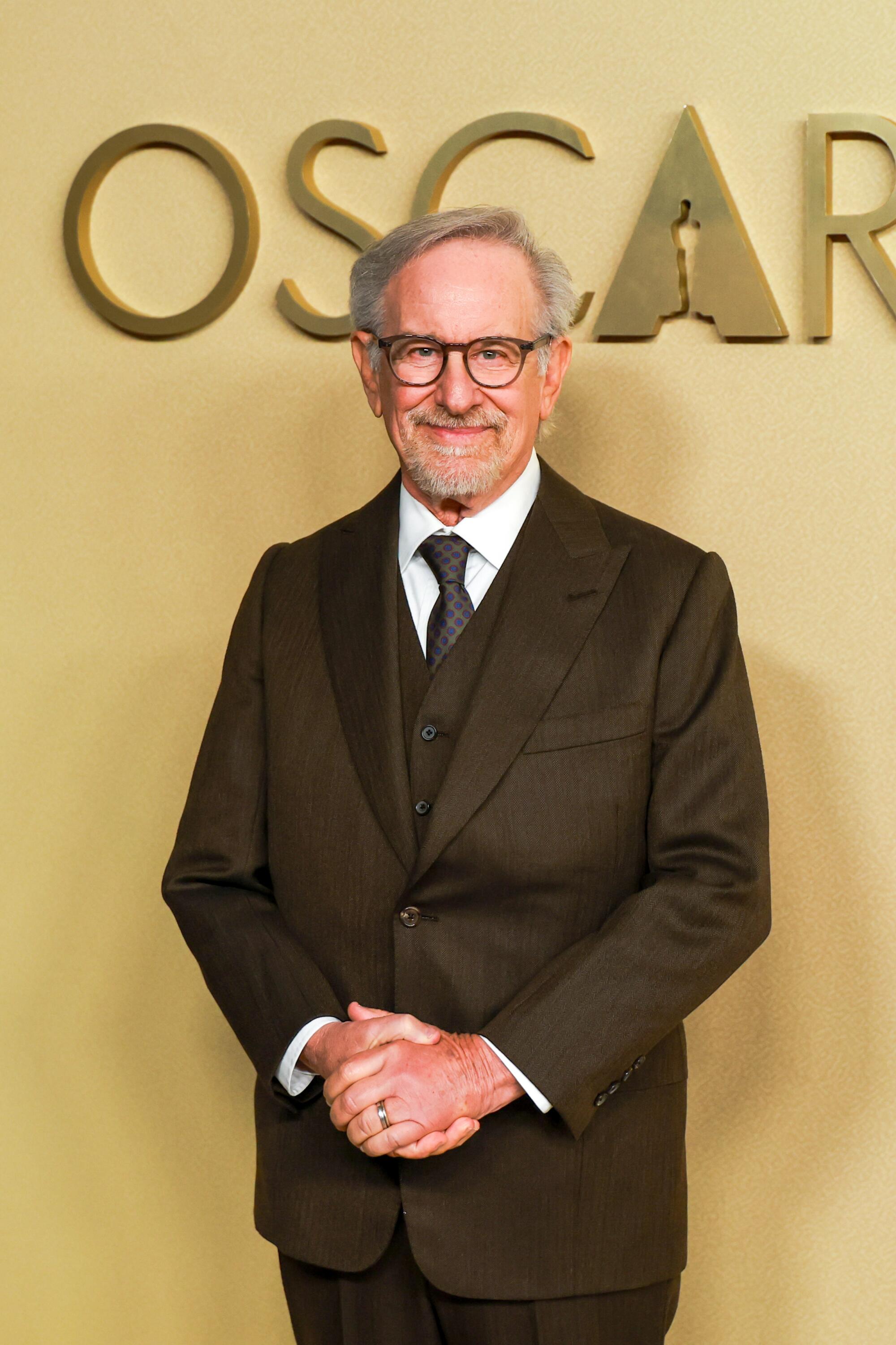 Steven Spielberg poses with hands crossed. 