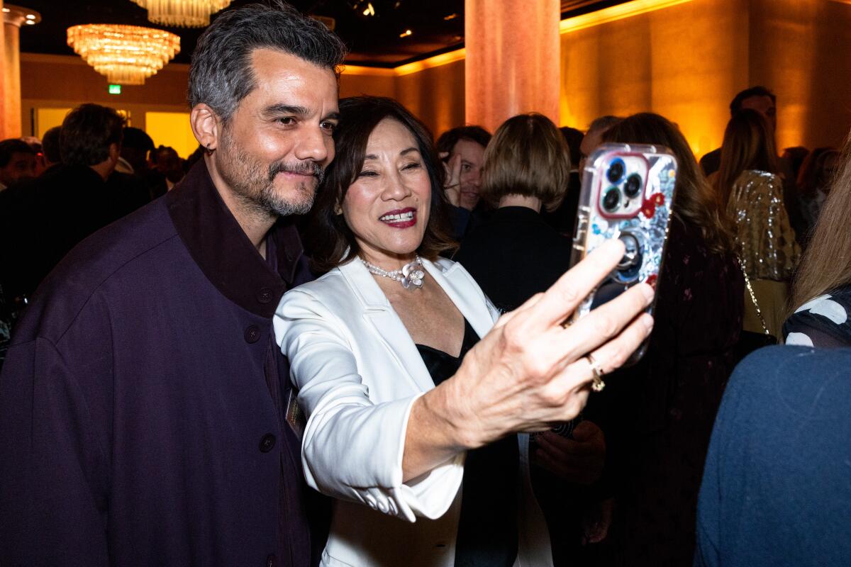 Two smiling people take a selfie.