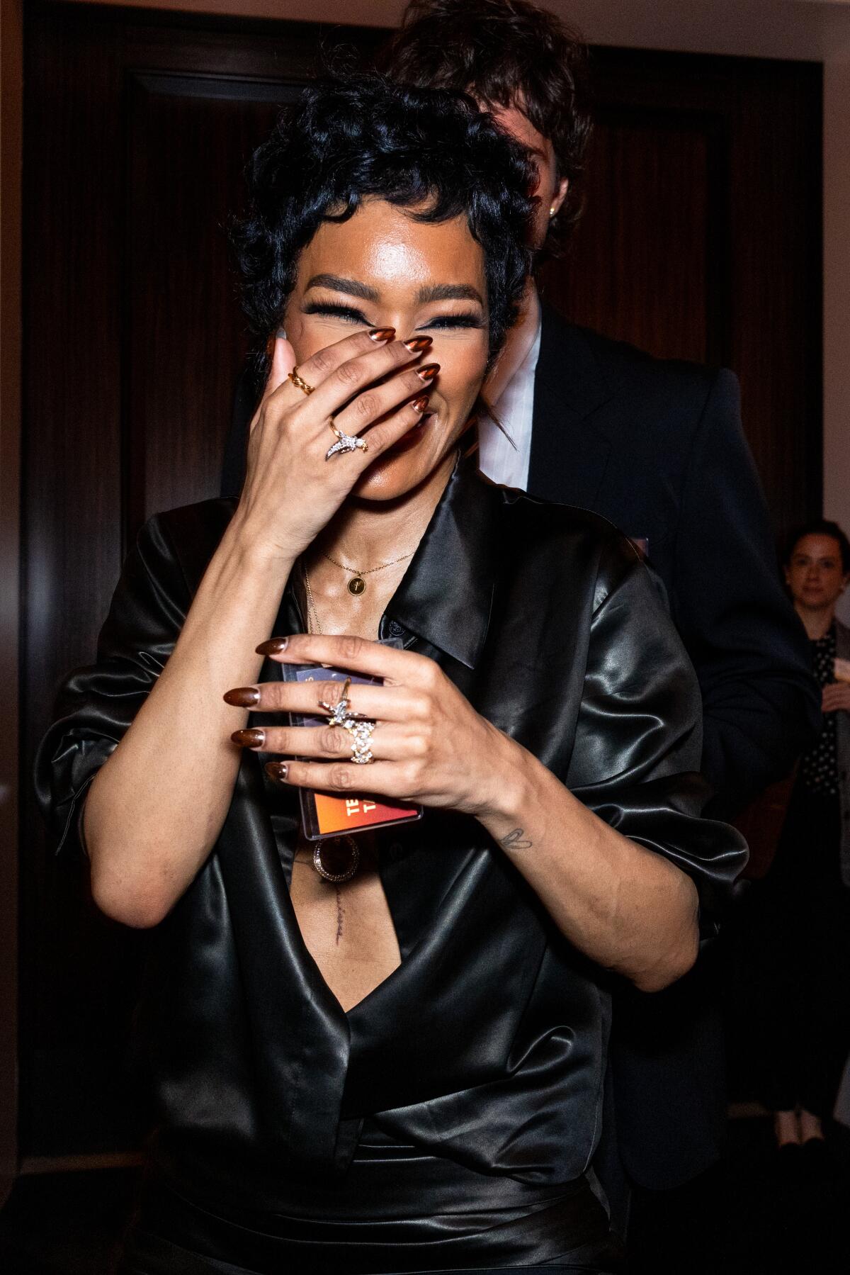 A woman smiles and laughs.