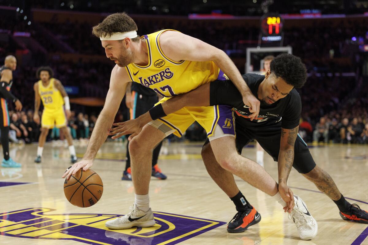 Lakers forward Drew Timme tries to fend off Spurs guard Dylan Harper in the first half.