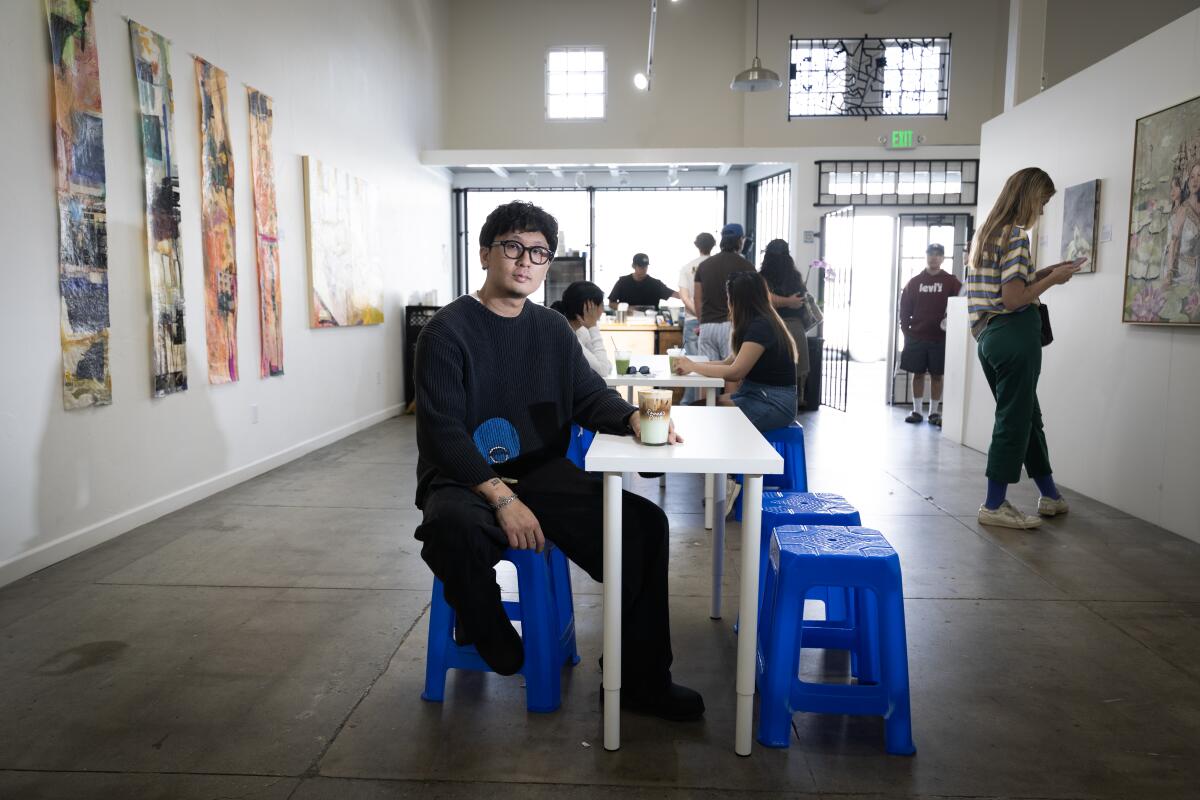 A man is photographed at his coffee shop 