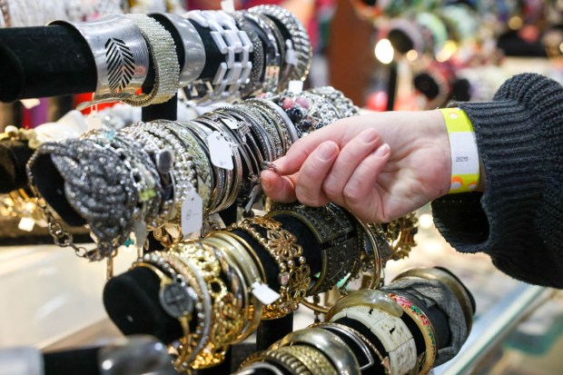 Coral Zolczynski, of Oakland, checks bracelets for sale in the jewelry department during Week 2 of the annual White Elephant Sale organized by the Oakland Museum Women's Board in Oakland, Calif., on Wednesday, Feb. 12, 2025. The popular sale draws hundreds of shoppers, and the funds raised during the event support the Oakland Museum of California's educational programs, exhibitions, and marketing. (Ray Chavez/Bay Area News Group)