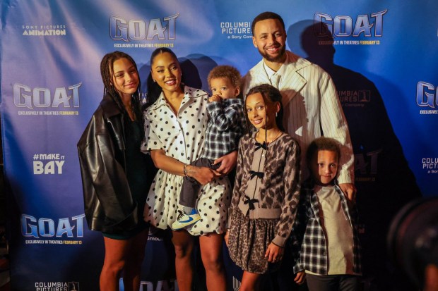 Ayesha Curry, second from left, and Golden State Warriors star Steph Curry, right, along with their children, pose for a family group photo on the red carpet for the screening of "GOAT" at the Grand Lake Theater in Oakland, Calif., on Tuesday, Feb. 10, 2026. The film "GOAT" was produced by Steph Curry. (Ray Chavez/Bay Area News Group)
